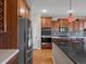 Kitchen features stainless steel appliances, wood cabinets, and a backsplash at 11545 S Flower Mound Way, Parker, CO 80134