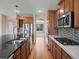 Gourmet kitchen boasts stainless steel appliances, and an island with seating at 11545 S Flower Mound Way, Parker, CO 80134