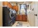 Spacious laundry room with washer, dryer, storage cabinets, and a utility sink at 11545 S Flower Mound Way, Parker, CO 80134