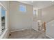 Spacious living room with neutral walls, lots of light from windows, and view of entryway with staircase at 11545 S Flower Mound Way, Parker, CO 80134