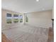 Bright living room with neutral carpet, recessed lighting, and many windows for lots of natural light at 11545 S Flower Mound Way, Parker, CO 80134