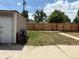 Backyard with a shed, green grass, and a wood fence for privacy and outdoor enjoyment at 1337 Valentia St, Denver, CO 80220