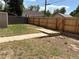 Backyard with a wooden fence, green grass, and a walkway for outdoor enjoyment and privacy at 1337 Valentia St, Denver, CO 80220