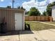 Backyard featuring a shed, green grass, and a wood fence for privacy and outdoor activities at 1337 Valentia St, Denver, CO 80220