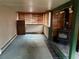 View of the basement with a retro carpet, paneled walls and a modern wood burning fireplace at 1337 Valentia St, Denver, CO 80220