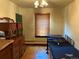 A bedroom with classic furnishings, a window with wooden blinds, and hardwood floors at 1337 Valentia St, Denver, CO 80220