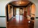 An entryway featuring beautiful wood floors, and trim, with a decorative archway at 1337 Valentia St, Denver, CO 80220