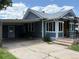 View of house exterior with a covered carport and view of the front entrance at 1337 Valentia St, Denver, CO 80220