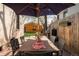 Backyard with outdoor dining under a large umbrella, barbecue grill, and two-car garage at 3534 Decatur St, Denver, CO 80211