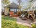Secluded backyard with a patio, lush lawn, mature trees, and wood fencing at 3534 Decatur St, Denver, CO 80211