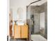 Stylish bathroom with a modern vanity, gold hardware, and a sleek glass-enclosed shower at 3534 Decatur St, Denver, CO 80211