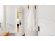 Bright bathroom with white towels hanging near an open door that leads to a bed at 3534 Decatur St, Denver, CO 80211