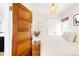 Inviting bedroom with hardwood floors, natural light, and a decorative light fixture at 3534 Decatur St, Denver, CO 80211