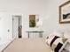 Well-lit bedroom with a modern mirror and a glimpse into the adjacent room at 3534 Decatur St, Denver, CO 80211