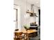 Bright dining area with modern pendant lighting and a view into the well-equipped kitchen at 3534 Decatur St, Denver, CO 80211