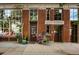 Exterior of Weir Building, a two-story brick building, with colorful flower pots at 3534 Decatur St, Denver, CO 80211