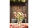 Close-up view of flowers in vase on outdoor dining table with pink runner at 3534 Decatur St, Denver, CO 80211