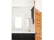 Stylish kitchen with white countertops, exposed brick, and contemporary black cabinetry at 3534 Decatur St, Denver, CO 80211