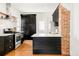 Bright kitchen boasts stainless steel appliances, a butcher block island, and white subway tile at 3534 Decatur St, Denver, CO 80211