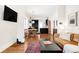 Spacious living area flows into dining and kitchen, featuring hardwood floors at 3534 Decatur St, Denver, CO 80211