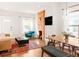 Cozy living room and dining area with exposed brick and a modern, open floor plan at 3534 Decatur St, Denver, CO 80211