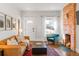 Bright living room with a decorative brick fireplace and comfortable, stylish furniture at 3534 Decatur St, Denver, CO 80211