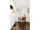 Bright sunroom with a desk, chair, hardwood floors, white brick and shiplap walls, and plenty of natural light at 3534 Decatur St, Denver, CO 80211