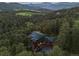 Stunning aerial view of a home nestled in a forest with mountain views and solar panels at 91 Hess Ave, Golden, CO 80401