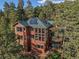 Aerial view of a home with solar panels on the roof surrounded by lush greenery at 91 Hess Ave, Golden, CO 80401