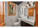 Modern half bath with sleek vanity, stylish lighting, and a window with a view of lush greenery at 91 Hess Ave, Golden, CO 80401