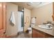 Neutral bathroom featuring a shower, toilet, sink, slate floors, and wooden accents at 91 Hess Ave, Golden, CO 80401