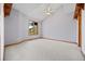 Spacious carpeted bedroom featuring large windows and vaulted ceiling with wooden beam accents at 91 Hess Ave, Golden, CO 80401