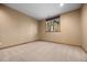 Neutral bedroom offers wall-to-wall carpet, a window with wooded views, and base trim details at 91 Hess Ave, Golden, CO 80401
