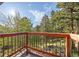 Elevated deck showcasing redwood railing with verdant views of the surrounding trees and natural landscape at 91 Hess Ave, Golden, CO 80401