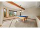 Brightly lit game room with a pool table and large window showcasing scenic outdoor views at 91 Hess Ave, Golden, CO 80401