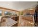 Well-appointed kitchen boasting tile countertops, custom wooden cabinets, and views of lush greenery at 91 Hess Ave, Golden, CO 80401