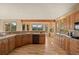 Large kitchen with tile countertops, updated appliances, and stunning views through the numerous surrounding windows at 91 Hess Ave, Golden, CO 80401