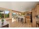 Spacious kitchen with wooden cabinetry, a center island with seating, and expansive windows overlooking nature at 91 Hess Ave, Golden, CO 80401