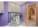 Contemporary laundry room with side-by-side washer and dryer and white cabinets at 91 Hess Ave, Golden, CO 80401