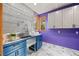 Bright laundry room with blue cabinets, stainless sink, wire shelving, and marble flooring at 91 Hess Ave, Golden, CO 80401