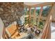 A unique view of the living room with large fireplace, beams, and many windows at 91 Hess Ave, Golden, CO 80401