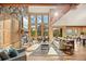 Open floorplan showcasing a fireplace, wooden beams, and expansive views from large windows at 91 Hess Ave, Golden, CO 80401