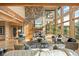 Cozy living room featuring a stone fireplace, hardwood floors, and expansive windows at 91 Hess Ave, Golden, CO 80401