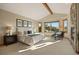 Bright main bedroom with a stone fireplace, scenic views, and stylish furnishings, offering a peaceful retreat at 91 Hess Ave, Golden, CO 80401