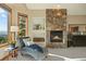 Comfortable main bedroom with a cozy stone fireplace, natural light, and elegant furnishings at 91 Hess Ave, Golden, CO 80401