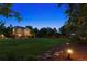 Spacious backyard with lush lawn, landscaped lighting, and mature trees create a private oasis at 3970 White Bay Dr, Highlands Ranch, CO 80126