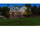 Exterior rear view of home featuring large landscaped backyard, lush lawn and paver patio at 3970 White Bay Dr, Highlands Ranch, CO 80126