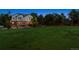 Beautiful backyard featuring lush green lawn, mature trees and large paver patio at 3970 White Bay Dr, Highlands Ranch, CO 80126