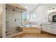 Luxurious bathroom with walk-in shower, soaking tub, and dual vanities at 3970 White Bay Dr, Highlands Ranch, CO 80126