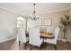Formal dining room featuring crown molding, hardwood floors, and a stylish chandelier at 3970 White Bay Dr, Highlands Ranch, CO 80126